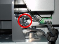 The third screw: On the right side of the paper holder.