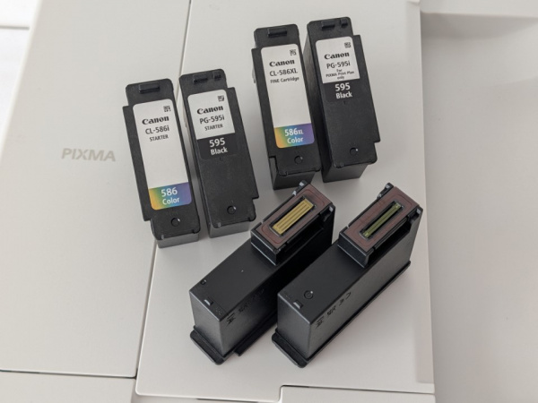 Druckkopfpatonen: Links sind die mit dem Drucker mitgelieferten Patronen dargestellt. Im Tintenabo liefert Canon Patronen mit den gleichen Dimensionen, aber deutlich höherer Reichweite. Mit jedem Tintenwechsel gibt es einen neuen Druckkopf, wie man auf den umgedrehten Patronen unten sieht.